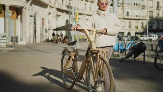 Woman walking with wooden bike
