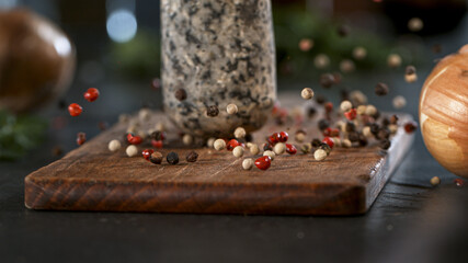 Freeze Motion Shot of Crushing Colored Peppers Balls in Mortar.