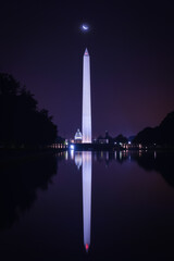 Washington DC Monuments including US Capitol and Washington Monument and ww2 monument with a crescent moon at night - Washington DC United States