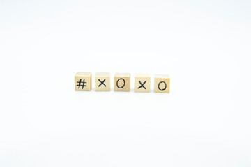 Word XOXO written on the wood cubes on white  background. The concept photo with letters #xoxo
