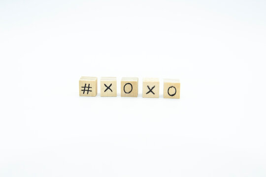 Word XOXO written on the wood cubes on white  background. The concept photo with letters #xoxo