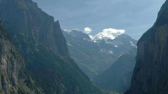 Aerial drone over the village of Lauterbrunnen and Staubbach Falls waterfall in Switzerland on a sunny day during summer 
