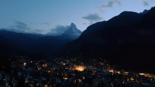 Aerial drone over the famous Zermatt village with the Matterhorn peak view in the alps in Switzerland at dusk 