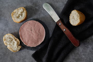 Delicious block of foie with bread on a dark background