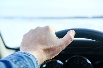 The image of steering wheel and hand