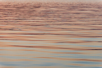 Abstract detail of calm ocean waves at dusk