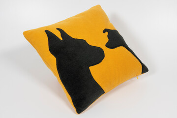 Yellow pillows with black dog silhouettes on a white background