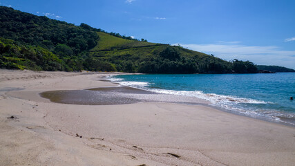 Brazilian woman in bikini on a deserted beach in Ubatuba, São Paulo, Brazil. Playing in the sea water
Atlantic forest, yellow sand and clear sea water. Figueira beach paradise.