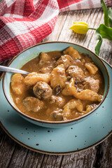 Meatballs in gravy with cast noodles.