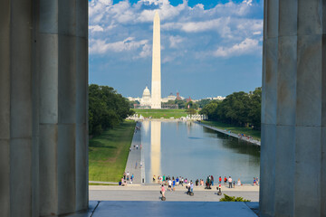 Washington DC monuments including the Capitol and Washington Monument as seen between columns of...