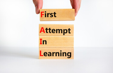FAIL first attempt in learning symbol. Wooden blocks with words FAIL first attempt in learning. Beautiful white table, white background, copy space. Business, FAIL first attempt in learning concept.