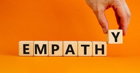 Empathy symbol. The concept word Empathy on wooden cubes. Beautiful orange table, orange...