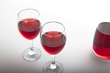 Closeup detail view of a bowl of red wine, backlit illuminated with reverse light includes copy space.