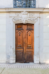 Fototapeta na wymiar Nimes in France, old facades in the historic center, beautiful wooden door 
