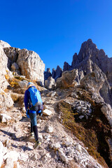 Young woman trekking on the via ferrata of Monte Paterno. Adventure activity in Dolomites, Italy