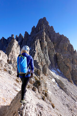Naklejka premium Woman trekking on Monte Paterno. Adventure activity in Dolomites, Italy