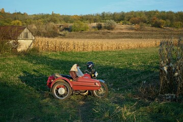 old red motorcycle near the corn field