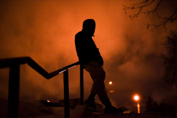 A silhouette (shadow) on the stairs at night in winter in the city
