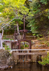 tokyo, japan - april 09 2021: Lock which opening and closing according the sea levels of Tokyo Bay adjusting the flow of water of the Seawater tidal pond named Shiori-no-ike in the Hama-rikyū Gardens.