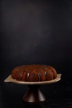 Chocolate bundt cake with chocolate chips on cake stand