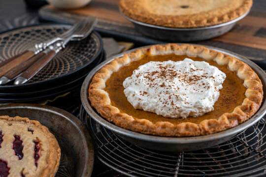 Assortment of holiday pies on dark surface