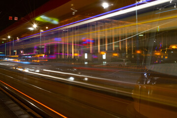 Fototapeta na wymiar Tram Lights in the Busy Streets of a Big City at Night