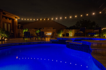 A night time view of a desert landscaped backyard in the American southwest.