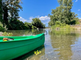 Front of canoe on peaceful river Tavignano with beautiful green nature. Corsica, France.