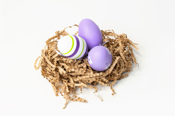 Easter eggs in a paper nest. Easter, purple eggs