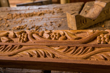a very beautiful ornament carved from wood in the process of work lies on the table very closely...