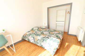 bedroom with green bed, white desk and green chair