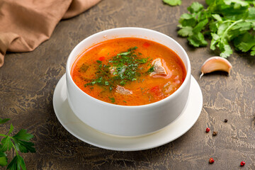 soup kharcho on bowl with meat on brown table