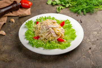fettuccine with ham and porcini mushrooms on white plate