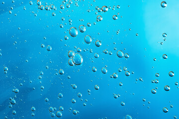 Close up macro Aloe vera gel serum cosmetic texture blue background with bubbles. Cruelty free....