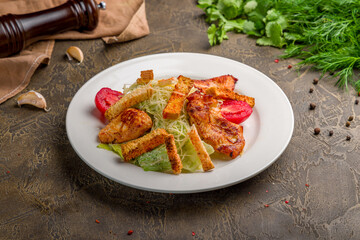 Salad caesar with chicken on white plate