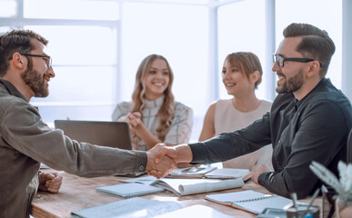 handshake business people at a meeting in the office