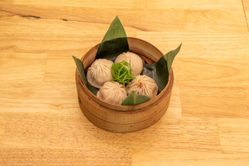 Xiaolongpao, a baozi-type stewed dumpling, is a very common culinary specialty of eastern China, including Shanghai and Wuxi. These stewed buns are usually steamed in bamboo baskets