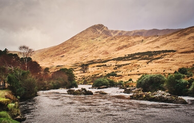 Beautiful cloudy landscape scenery with of river Erriff with mountains in the background at Aesleagh in county Mayo, Ireland 