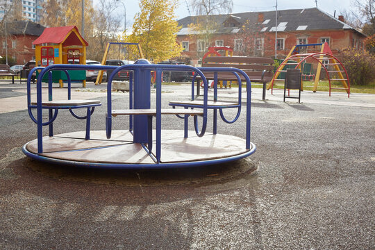 empty carousel on a playground on an autumn sunny day