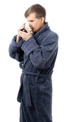 portrait of a man in a gray terry bathrobe. happy, healthy Man holds a mug of water. drinking more water is good for your health. better at home, stay home. quarantine. isolated.