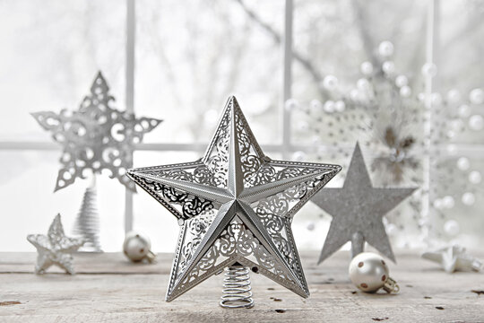 Vintage silver Christmas star tree toppers on a table