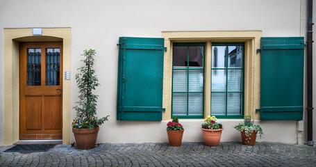 Facade of an old swiss house with the front door and window