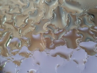 Macro of water droplets on glass with defocused background