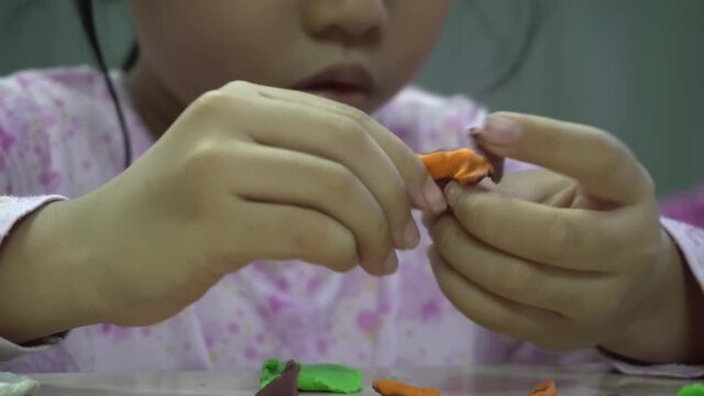 A kid segregate the ABC block in different color.