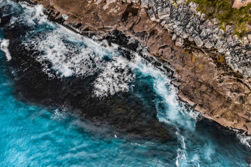 Obraz premium Long Exposure Drone Shot of Shelly Headland Waves