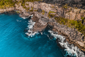 Fototapeta na wymiar Long Exposure Drone Shot of Shelly Headland Waves