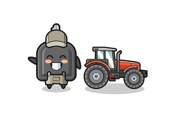 the car key farmer mascot standing beside a tractor