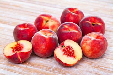 Obraz na płótnie Canvas Fresh juicy peaches on wooden background, harvest season