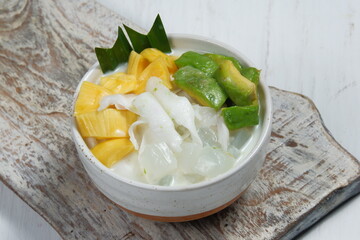 Ice teler or es teler-indonesian fruit cocktail,Avocado, young coconut, jackfruit, served with coconut milk, sweetened condensed milk.