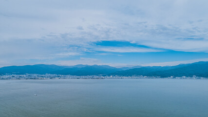 Drone shot of Lake Suwa & Kiso Mountains. Nagano Japan